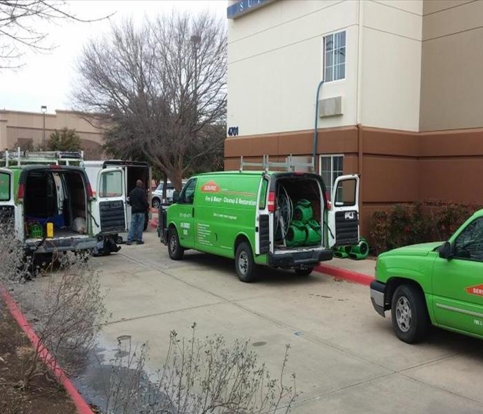 SERVPRO trucks parked in front of a hotel